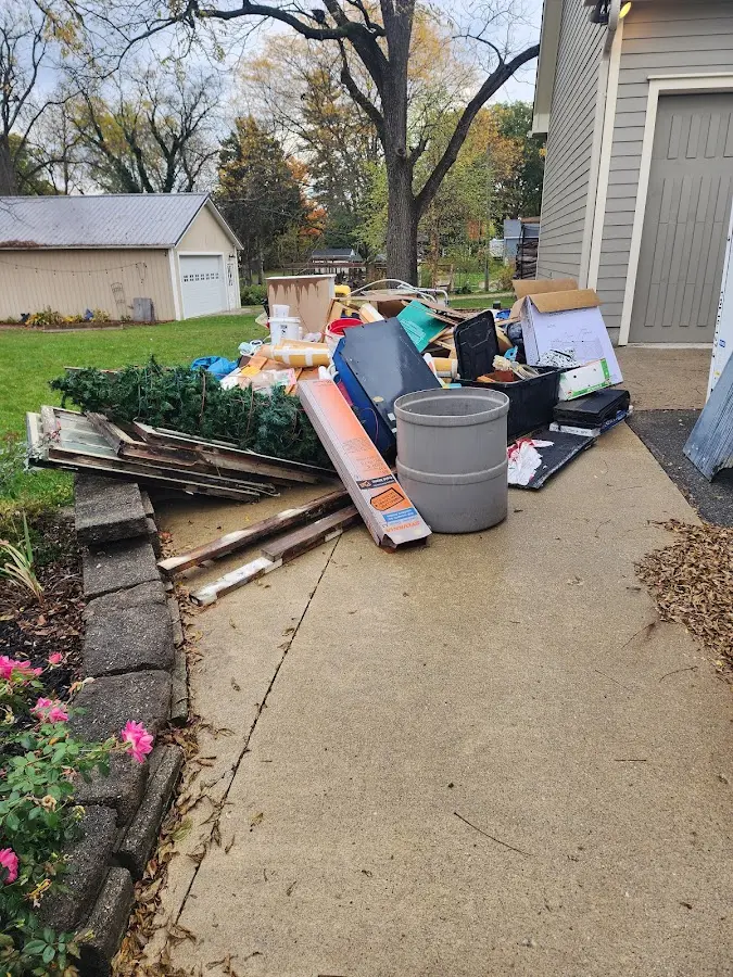 Dumpster being loaded with debris for Roofing Dumpster Rental in Atlantic Beach